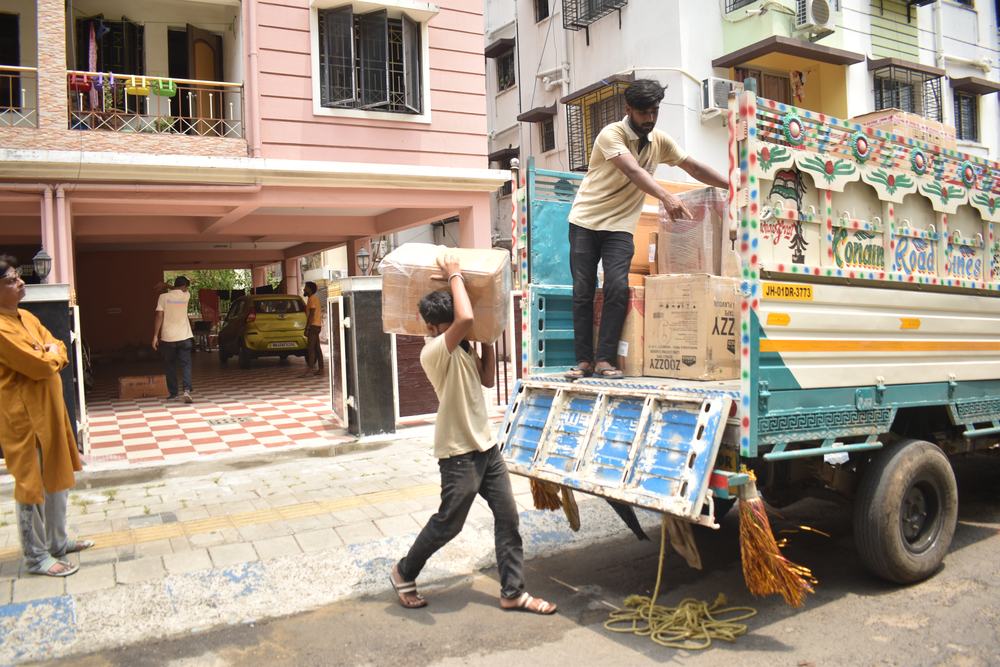 Movers unloading boxes from a truck